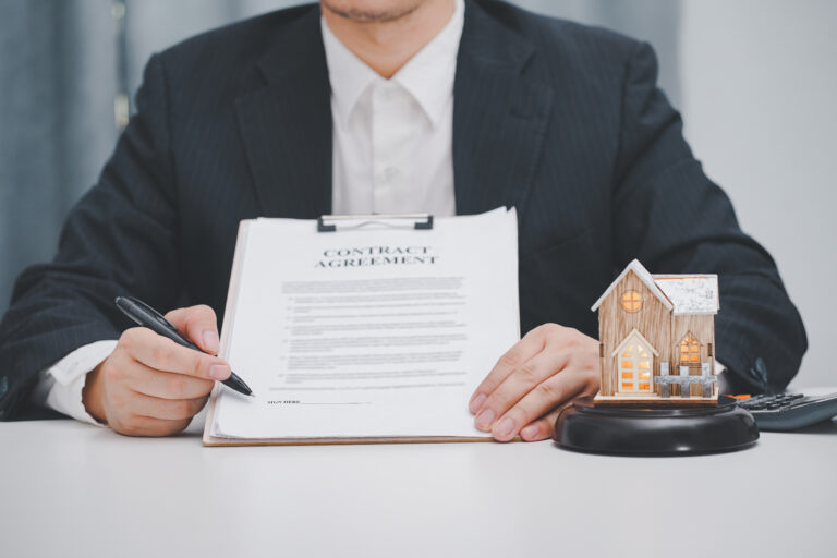 Real estate agent showing contract agreement at office. Home sales and home insurance concept.